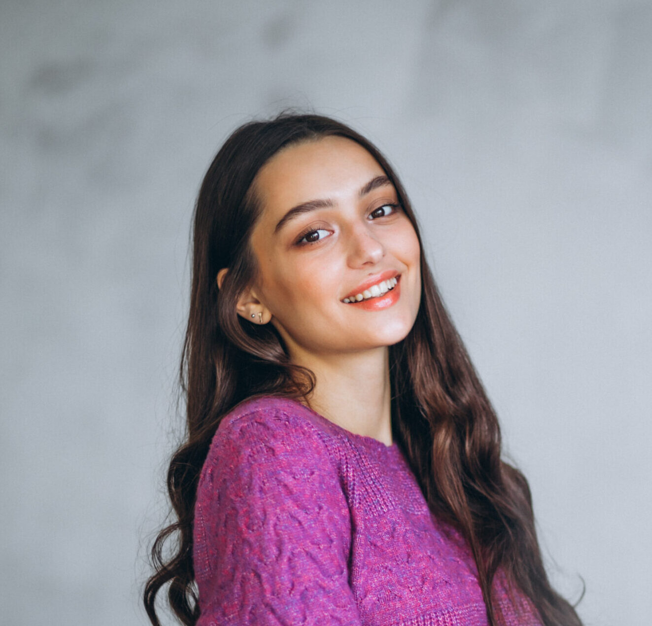 beautiful woman in a purple sweater and skirt in studio